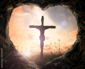 Good Friday concept: Heart shape of cave with Jesus Christ on cross over meadow sunset background.