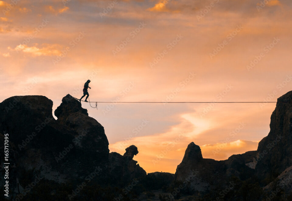 An acrobat walking the slackline