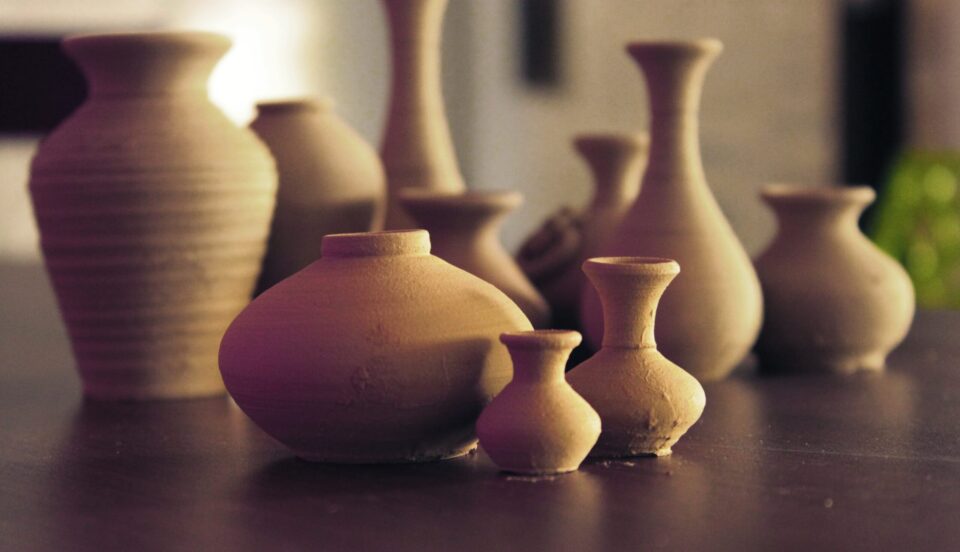 brown ceramic vases on wooden surface