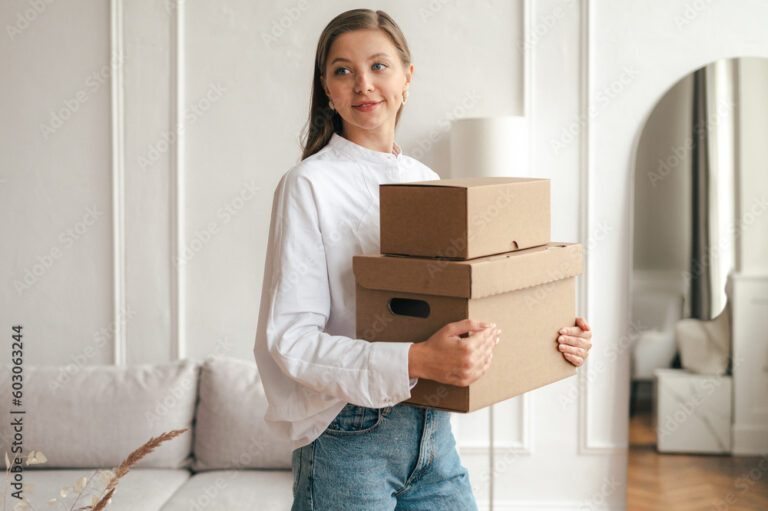 Calm woman with carton boxes in living room