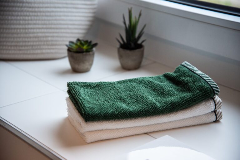 folded towels near potted plants