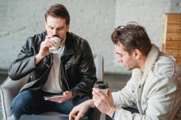 Friends sitting together and drinking coffee