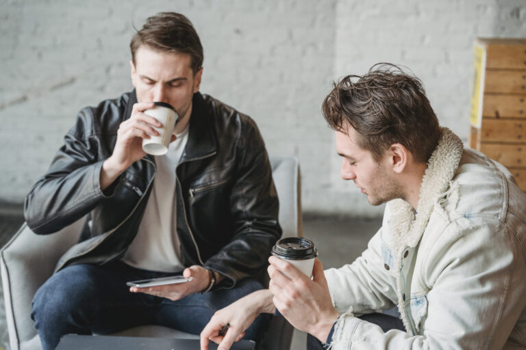 Friends sitting together and drinking coffee