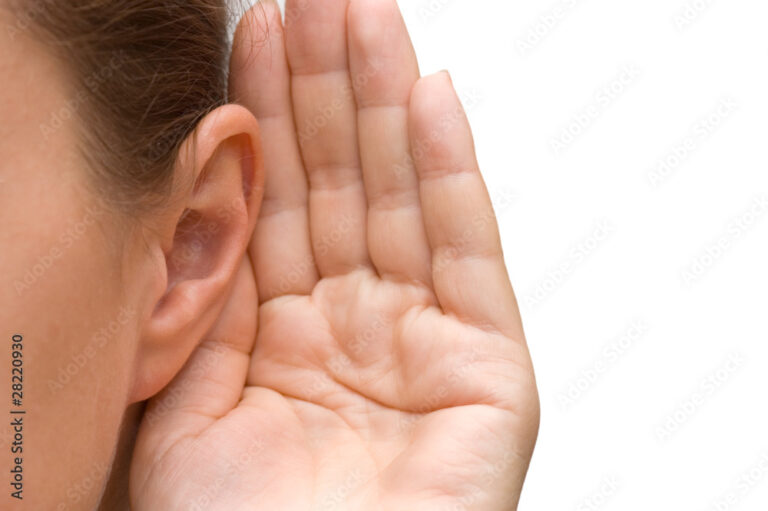 Girl listening with her hand on an ear