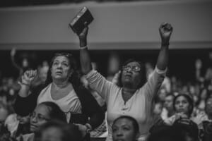 Grayscale photography of people worshiping