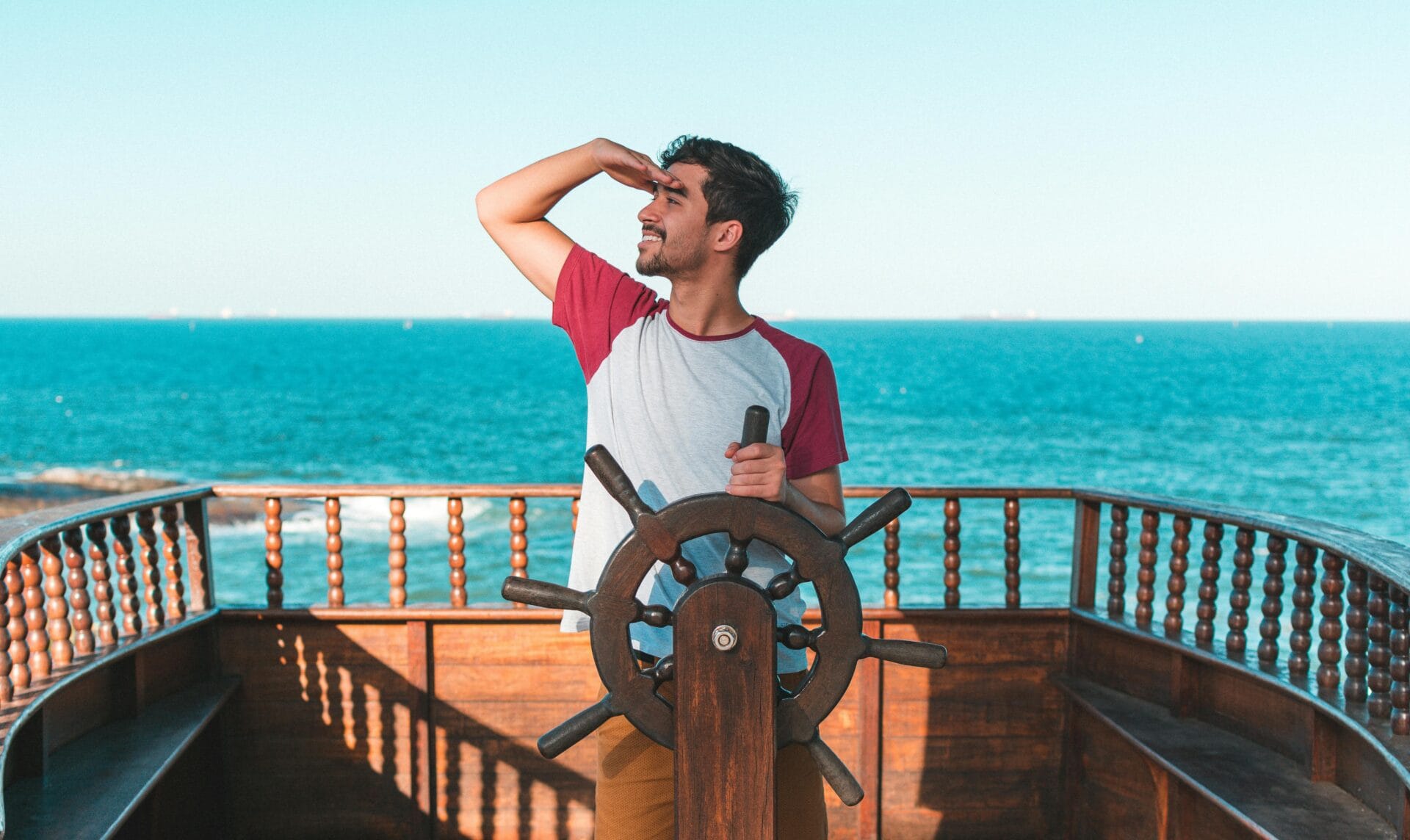 Man holding ship s wheel