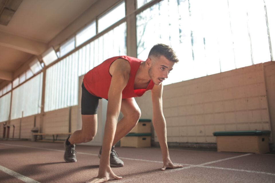 Man in red tank top is about to run