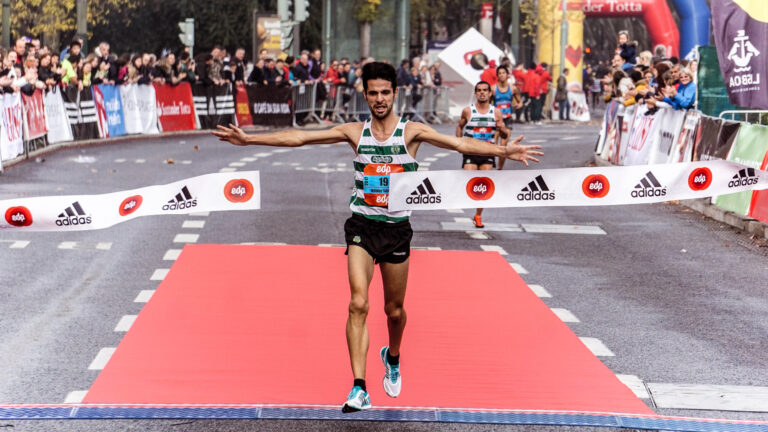 Man running on black asphalt road