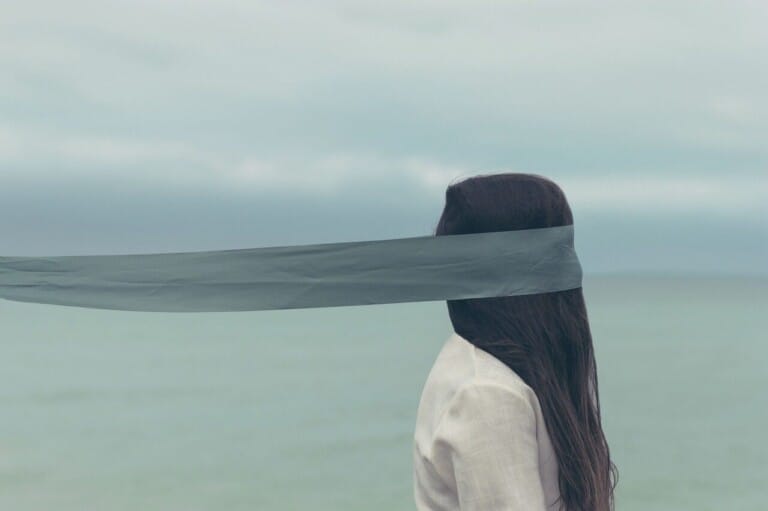 people, woman, cloth, hair, blind flold, water, ocean, sea, beach, clouds, sky, nature, cloth, cloth, cloth, cloth, cloth