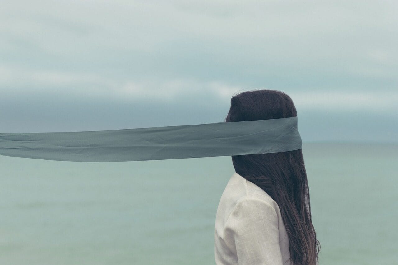 people, woman, cloth, hair, blind flold, water, ocean, sea, beach, clouds, sky, nature, cloth, cloth, cloth, cloth, cloth