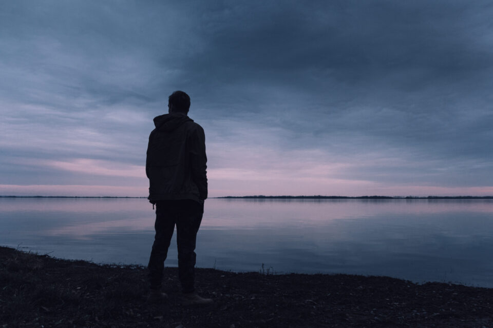 Person standing near lake