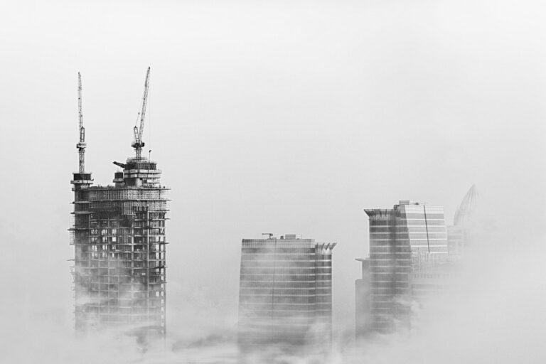 Photo of skyscrapers surrounded with clouds