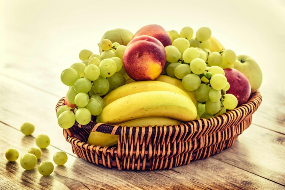 Several fruits in brown wicker basket