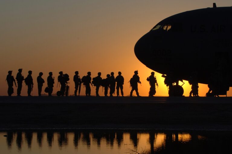 Soldiers in line to get in a plane