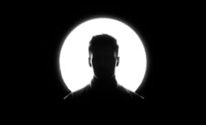 This striking photo was the result of meticulous planning and setup over several days. To create the effect, we used an 8’x8’ foam board with a precisely cut 12”x12” circle at its center. A powerful 700W Softbox Light was positioned behind the board, allowing light to shine exclusively through the circular opening. After fine-tuning the camera settings, the perfect shot emerged. Interestingly, my head wasn’t the original choice for the silhouette, but it ultimately became the most captivating focal point of the composition.