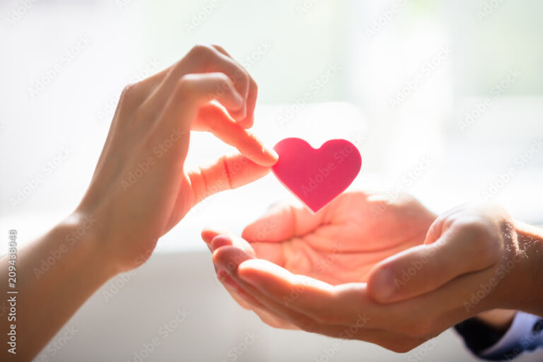 Woman Giving Heart On Man's Hand