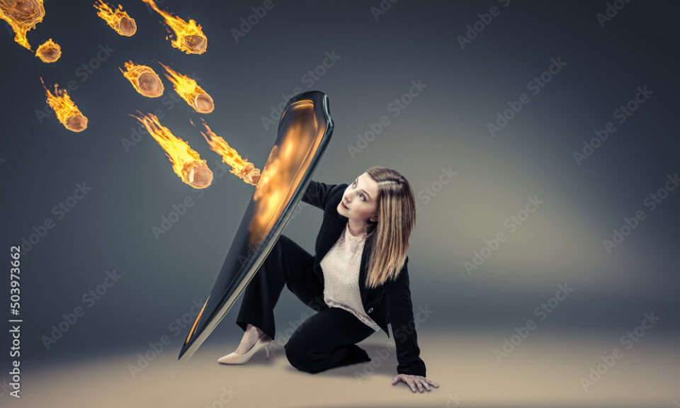 woman protects herself with a shield