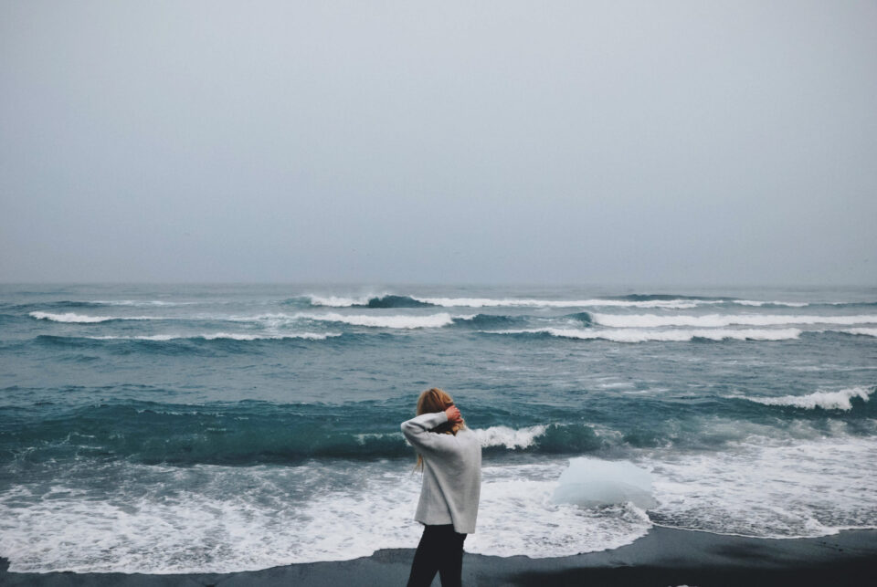 Woman walking beside seashore