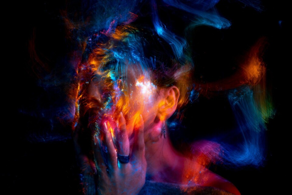 Woman with orange and blue powder on her face