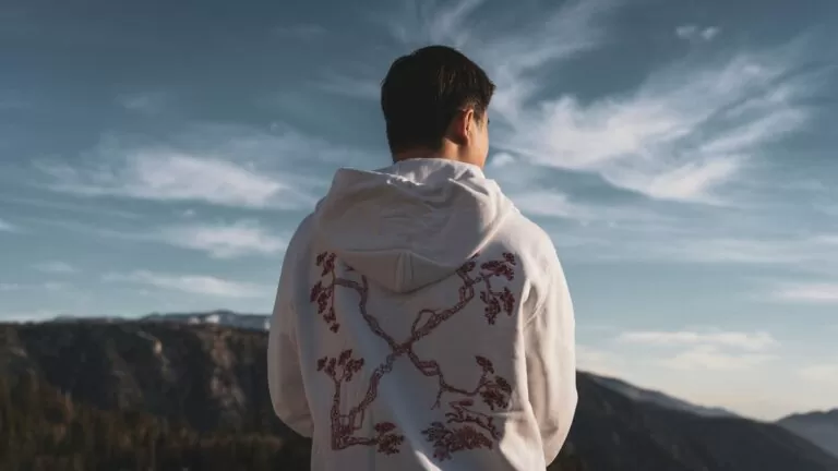 a man standing on top of a mountain looking at the sky