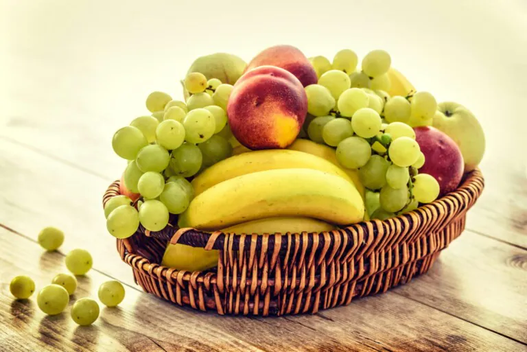 Several fruits in brown wicker basket